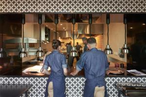 two men standing at a counter in a kitchen at Les Suites at The Cliff Bay - PortoBay in Funchal