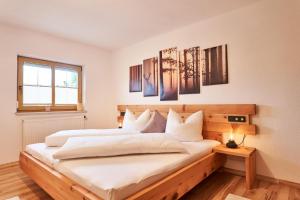 a bedroom with two beds with white sheets at Ferienwohnung Schatz in Breitenwang