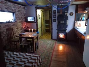 a dining room with a table and a fireplace at Scandinavia bungalow in Kamennaya Gora