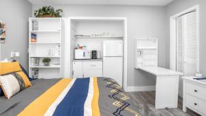 a white bedroom with a bed and a desk at Cozy 1 BDR Unit by Beach, Mall, & Downtown FTL in Fort Lauderdale