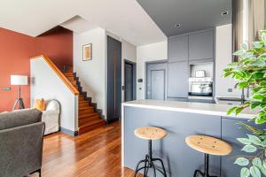 a kitchen and living room with a counter and stools at Centrally Located Flat with Balcony in Beyoglu in Istanbul