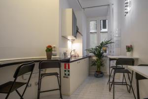 a kitchen with a counter and stools in a room at Intra' Residenza in Trastevere in Rome