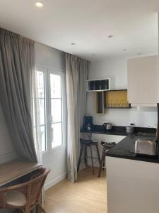 kuchnia z blatem, stołem i oknem w obiekcie Studio Saint Germain des près w Paryżu