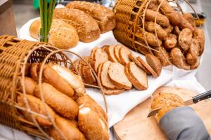 a bunch of breads and pastries on a table at Merom Golan Resort in Merom Golan