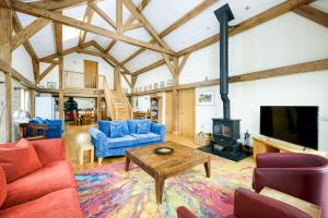 a living room with a fireplace and a tv at Lakeside property with hot tub Barn Owl HM08 in Somerford Keynes