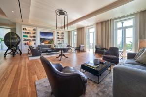 a living room with couches chairs and a table at Les Suites at The Cliff Bay - PortoBay in Funchal