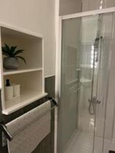a bathroom with a shower with a glass door at Ugly Duckling, License number FI 00863 P in Fife