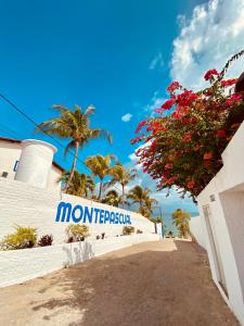 a sign for a hotel on the side of a building at Montepascual Ecovillage in Lagoinha +55 photos