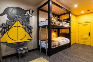 a bedroom with two bunk beds with a mural on the wall at Emily Magic Hostel in Vynnyky