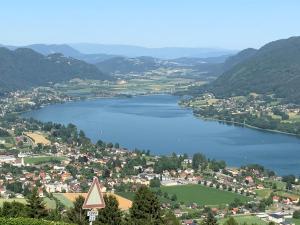 arial view of a town and a lake with mountains at kleines Seeglück in Feldkirchen in Kärnten