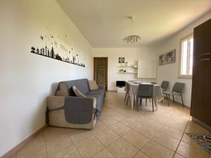 a living room with a couch and a table at Case Vacanze Paradise Beach Vicino Cefalù PISCINA APERTA in Campofelice di Roccella