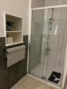 a shower with a glass door in a bathroom at Ugly Duckling, License number FI 00863 P in Fife