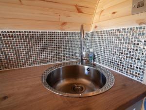 a sink in a kitchen with tiles on the wall at Boreray - Uk40644 in Trumisgarry