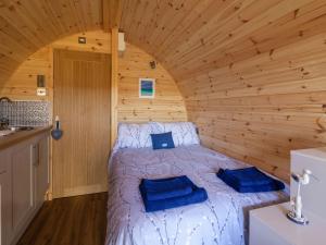 a bedroom with a bed in a wooden room at Boreray - Uk40644 in Trumisgarry