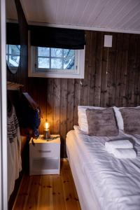 a bedroom with a large bed and a window at Vollsnes Feriehus in Hjelle