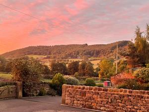 a brick wall with a view of a mountain at The Bobbin in Ashover