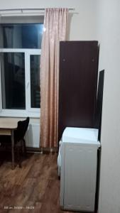a room with a bed and a table and a window at APARTMENT IN BALTI LIB HOUSE in Bălţi