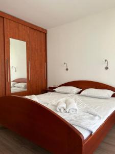 a bedroom with a large bed with white sheets at Apartment Aurora in Moravske Toplice