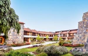 an exterior view of the courtyard of a resort at Merom Golan Resort in Merom Golan