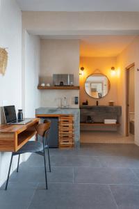 eine Küche mit einem Schreibtisch, einem Waschbecken und einem Spiegel in der Unterkunft Illa Cozumel in Cozumel
