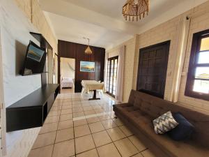 a living room with a couch and a table at Pousada Genoveva - Casa a beira mar in Laguna