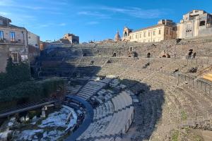 an empty amphitheater with buildings in the background at Finestre sul Teatro - Catania - Parking included in Catania