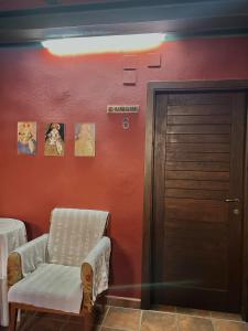 a room with a chair next to a door at Hostal meson del rey in Olocau del Rey