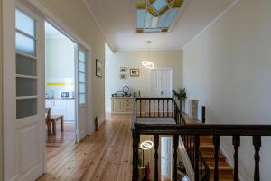 a hallway of a home with a staircase and a living room at Sky Accommodations Studio 2 in Coimbra