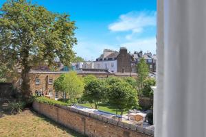 a view of a city from the window of a building at Hamilton Apartments hosted by Maysa London in London