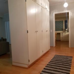 duża biała szafka w salonie z dywanem w obiekcie Tilava kolmio keskustassa w mieście Ylivieska