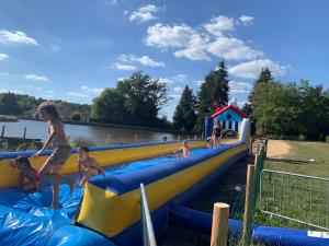 a group of children playing on an inflatable slide at Camping municipal de la Lande in Nexon