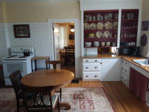 a kitchen with a wooden table and a kitchen with a stove at Terrapin Hostel in Kingfield