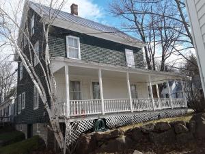 an old house with a large white porch with a porch at Terrapin Hostel in Kingfield +5 photos