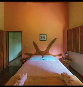 a bedroom with a bed with two people laying on it at Pousada Rio das Almas in Pirenópolis