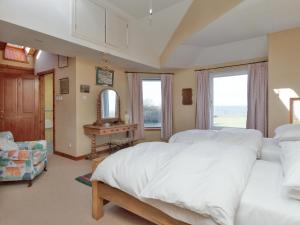 a bedroom with two beds and a mirror at Bentfield in Prestwick