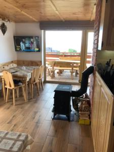 a living room with a table and a dining room at DOM u WIECHA in Huba