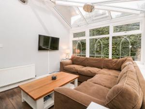 a living room with a couch and a table at Tree of Life House, Number 27 Bere Lane in Glastonbury