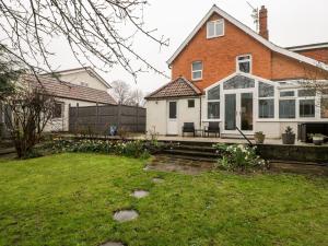 a house with a porch and a yard at Tree of Life House, Number 27 Bere Lane in Glastonbury
