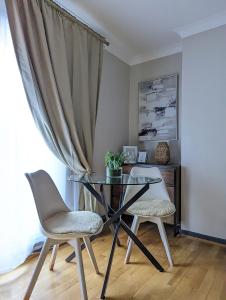 a dining room with a glass table and two chairs at 1BD apartment with balcony in Hoxton - Zone 1 in London