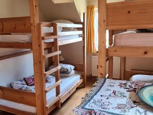 a room with three bunk beds in a house at Watercolour in Ardgour