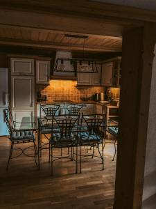 comedor con mesa y sillas en la cocina en Kuhlinarik Apartment, en Prama