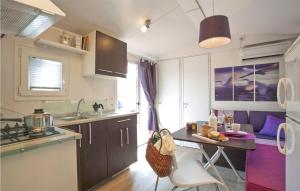 a kitchen with a table and a counter top at Pet Friendly Stacaravan in Tuoro sul Trasimeno