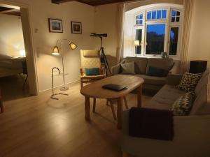 a living room with a couch and a table at Fjordvejen Apartments in Gråsten