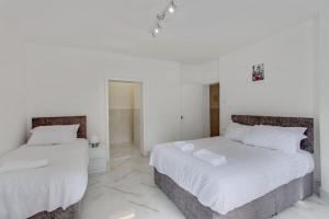Ένα ή περισσότερα κρεβάτια σε δωμάτιο στο Hamilton Apartments hosted by Maysa London