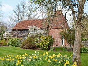 a house with a bunch of flowers in front of it at Cowford Oast in Mark Cross