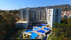 an aerial view of a building with blue umbrellas at Park Veredas Resort in Rio Quente