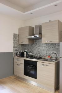A kitchen or kitchenette at •TO ROME WITH LOVE•