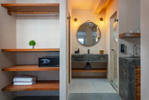 a bathroom with a sink and a mirror at Illa Cozumel in Cozumel