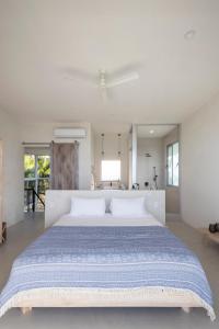 a large white bedroom with a large bed at Akwa Resorts Ocean View in Santa Teresa Beach