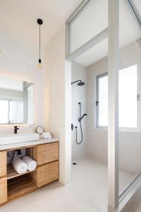 a bathroom with a sink and a shower at Akwa Resorts Ocean View in Santa Teresa Beach